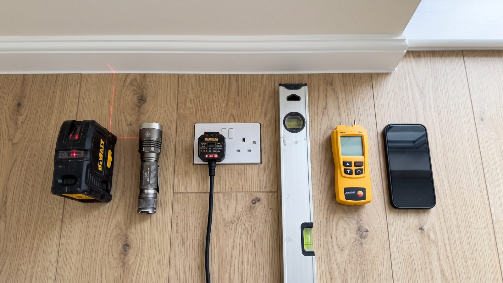 Snagging tools laid out on a new laminate floor