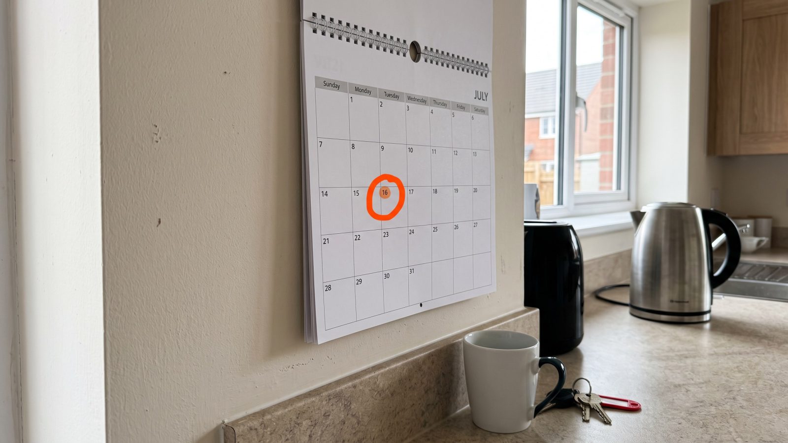 Wall calendar with a date circled in a new-build kitchen