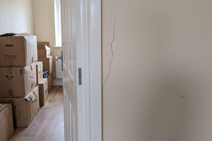 Shrinkage crack from a door frame in a lived-in new-build hallway